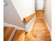 View of a wooden staircase leading down to the lower floor with hardwood floors at 2211 Oberlin Ave, Orlando, FL 32804