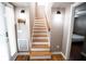 Stairway leading upstairs with hardwood steps and floors, alongside a decorative wall lamp at 2211 Oberlin Ave, Orlando, FL 32804