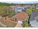 An aerial view of a home with brown roof, lush landscaping, and nearby homes at 2215 Mallard Creek Cir, Kissimmee, FL 34743