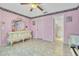 Bedroom with pink walls and an ensuite bathroom, adorned with a vintage vanity at 2215 Mallard Creek Cir, Kissimmee, FL 34743