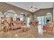 Ornate living room with detailed ceiling design, mirrored walls, tile flooring, and patio access at 2215 Mallard Creek Cir, Kissimmee, FL 34743