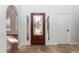 Foyer with a decorative front door, tile flooring, and white walls, creating a bright and welcoming entry at 2217 Wekiva Reserve Blvd, Apopka, FL 32703