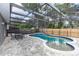 Backyard with a private screened-in pool, built-in spa, and patio at 2217 Wekiva Reserve Blvd, Apopka, FL 32703