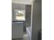 Bathroom features a modern tub with stylish gray tiling and natural light at 2380 Corbett Rd, Orlando, FL 32826