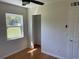 A bedroom featuring hardwood floors, closet, a window, and neutral walls at 2380 Corbett Rd, Orlando, FL 32826
