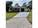 Charming single-story home features a lovely front porch, spacious driveway, and well-maintained landscaping at 2380 Corbett Rd, Orlando, FL 32826