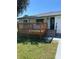 Charming exterior showcasing the house with a wooden deck and lush green lawn at 2380 Corbett Rd, Orlando, FL 32826