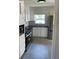 Modern kitchen featuring white cabinets, stainless steel appliances, black countertops, and tile backsplash at 2380 Corbett Rd, Orlando, FL 32826