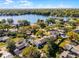 An aerial view of a residential neighborhood situated along a scenic lake, surrounded by mature trees at 2424 Shrewsbury Rd, Orlando, FL 32803