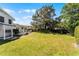 Lush green lawn surrounded by mature trees in this expansive backyard at 2424 Shrewsbury Rd, Orlando, FL 32803