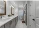 Elegant bathroom featuring a double vanity with gray cabinets and a glass-enclosed shower at 2424 Shrewsbury Rd, Orlando, FL 32803