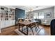 Cozy dining room featuring a stone fireplace, custom shelves, and a rustic wooden table at 2424 Shrewsbury Rd, Orlando, FL 32803