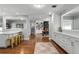 Open-concept kitchen featuring white cabinetry, hardwood floors, and modern design at 2424 Shrewsbury Rd, Orlando, FL 32803