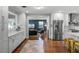 Modern kitchen with stainless steel appliances and white cabinetry open to the living room at 2424 Shrewsbury Rd, Orlando, FL 32803