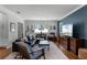 Well-lit living room featuring hardwood floors, a cozy seating area, and neutral decor at 2424 Shrewsbury Rd, Orlando, FL 32803