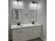 Bathroom featuring double sinks, quartz countertops, and sleek black fixtures, with great lighting at 258 Fraser Rd, Debary, FL 32713