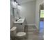 Bathroom boasting double sinks, quartz countertops, sleek black fixtures, and a modern toilet at 258 Fraser Rd, Debary, FL 32713