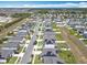 A lovely aerial view showcases a neighborhood, complete with sidewalks, solar panels and green space at 297 Citrus Isle Loop, Davenport, FL 33837