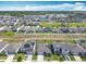 Panoramic aerial view of a vibrant community, featuring well-maintained homes with manicured lawns and solar panels at 297 Citrus Isle Loop, Davenport, FL 33837