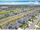 Sprawling aerial view of a modern community, showcasing well-kept homes with solar panels and green spaces at 297 Citrus Isle Loop, Davenport, FL 33837