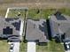 Aerial shot of a well maintained single-story home with solar panels surrounded by green grass at 297 Citrus Isle Loop, Davenport, FL 33837