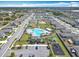 An aerial view features a community pool surrounded by homes, green space and sidewalks at 297 Citrus Isle Loop, Davenport, FL 33837