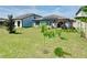 Lush green backyard with a young tree, pergola, and privacy fence providing a serene outdoor space at 297 Citrus Isle Loop, Davenport, FL 33837