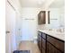 Bathroom featuring double sinks, quartz countertop, dark cabinets and a walk in shower at 297 Citrus Isle Loop, Davenport, FL 33837