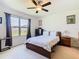 Inviting bedroom with a ceiling fan and large window bringing in lots of natural light at 297 Citrus Isle Loop, Davenport, FL 33837