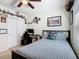 Modern bedroom with striped bedding, computer desk, and shelving that surrounds the room at 297 Citrus Isle Loop, Davenport, FL 33837