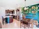 Stylish dining area with decorative wall, pendant lighting and stainless steel appliances at 297 Citrus Isle Loop, Davenport, FL 33837