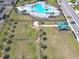 Aerial view of community fenced dog park near pool, with dog run and lush green space, excellent for pet owners at 297 Citrus Isle Loop, Davenport, FL 33837