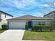 Charming single-story home features a manicured lawn, a two-car garage and lovely curb appeal at 297 Citrus Isle Loop, Davenport, FL 33837