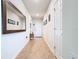 Bright hallway with neutral tile flooring and large decorative mirror at 297 Citrus Isle Loop, Davenport, FL 33837