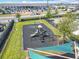 This playground features a shaded picnic table, lush green grass and modern play equipment at 297 Citrus Isle Loop, Davenport, FL 33837