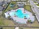 Aerial view of a community pool with lounge chairs and lush landscaping, perfect for relaxation and leisure at 297 Citrus Isle Loop, Davenport, FL 33837