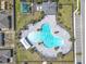 Aerial view of a community clover-shaped pool with lounge chairs and umbrellas, great for socializing at 297 Citrus Isle Loop, Davenport, FL 33837