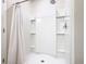 All-white shower stall with detachable shower head and built in shower caddy at 297 Citrus Isle Loop, Davenport, FL 33837