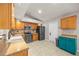 Spacious kitchen featuring wooden cabinets, stainless steel appliances, and stone tile flooring at 3093 S Horizon Pl, Oviedo, FL 32765