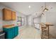 Bright kitchen with wood cabinets, stone tile floor and counter with blue accent cabinet at 3093 S Horizon Pl, Oviedo, FL 32765