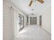 Bright sunroom with tile flooring, ceiling fans and sliding glass doors leading to the outside at 3093 S Horizon Pl, Oviedo, FL 32765