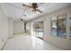 Bright sunroom with tile flooring, a ceiling fan, and large sliding doors leading to the pool at 3093 S Horizon Pl, Oviedo, FL 32765