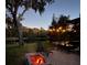 Backyard fire pit with view of screened in lanai and lake at 321 Cape Sable Dr, Orlando, FL 32825