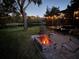 Cozy backyard featuring a brick fire pit and tranquil lake view at 321 Cape Sable Dr, Orlando, FL 32825