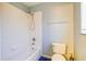 Bathroom with white tiled shower/tub, toilet, and blue tiled floor at 321 Cape Sable Dr, Orlando, FL 32825