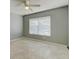 Cozy bedroom with tile floors, ceiling fan, a large window, and neutral walls at 321 Cape Sable Dr, Orlando, FL 32825