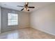 Neutral bedroom features large windows, tile floors, and a ceiling fan at 321 Cape Sable Dr, Orlando, FL 32825