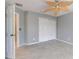 Comfortable bedroom with a decorative fan, tile flooring, and a double door closet at 321 Cape Sable Dr, Orlando, FL 32825