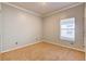 This cozy bedroom features neutral carpet, base molding, and a bright window at 321 Cape Sable Dr, Orlando, FL 32825