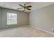 Cozy bedroom with tile floors, ceiling fan, a large window, and neutral walls at 321 Cape Sable Dr, Orlando, FL 32825